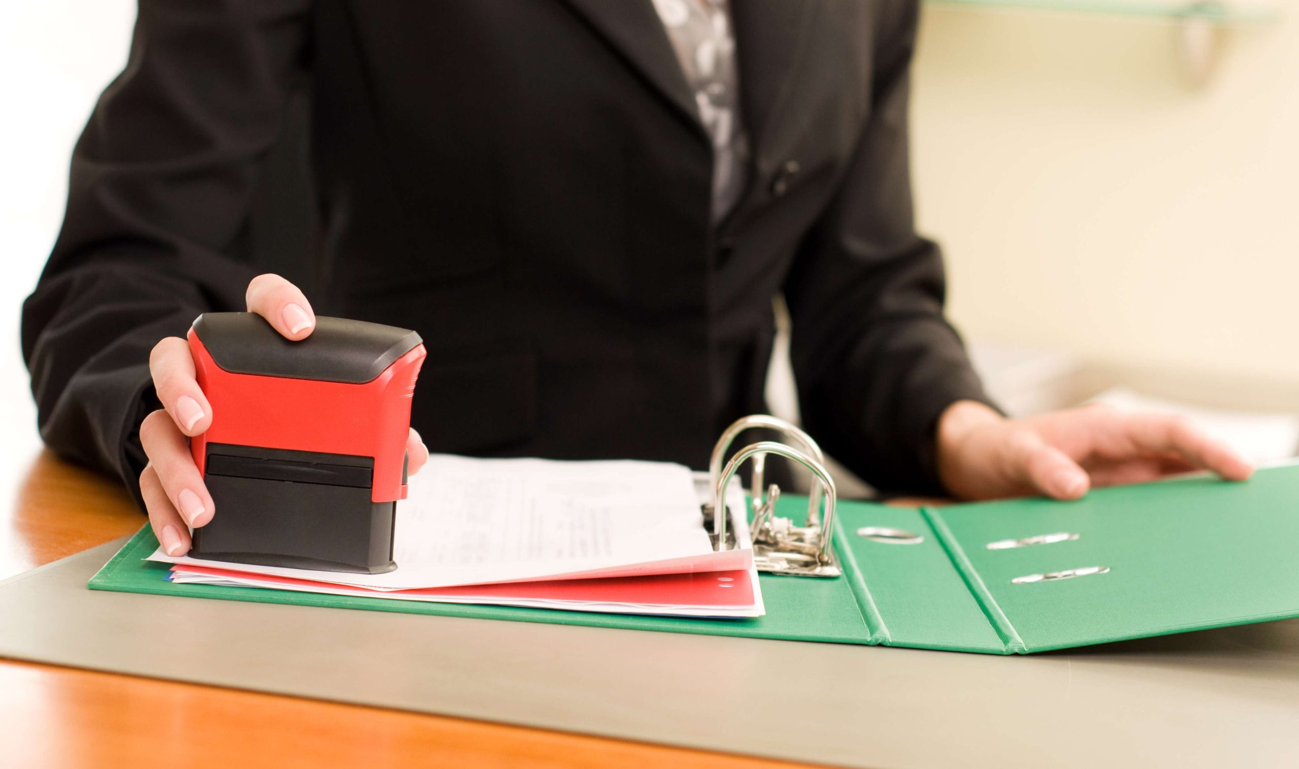 Woman’s hand with stamping documents