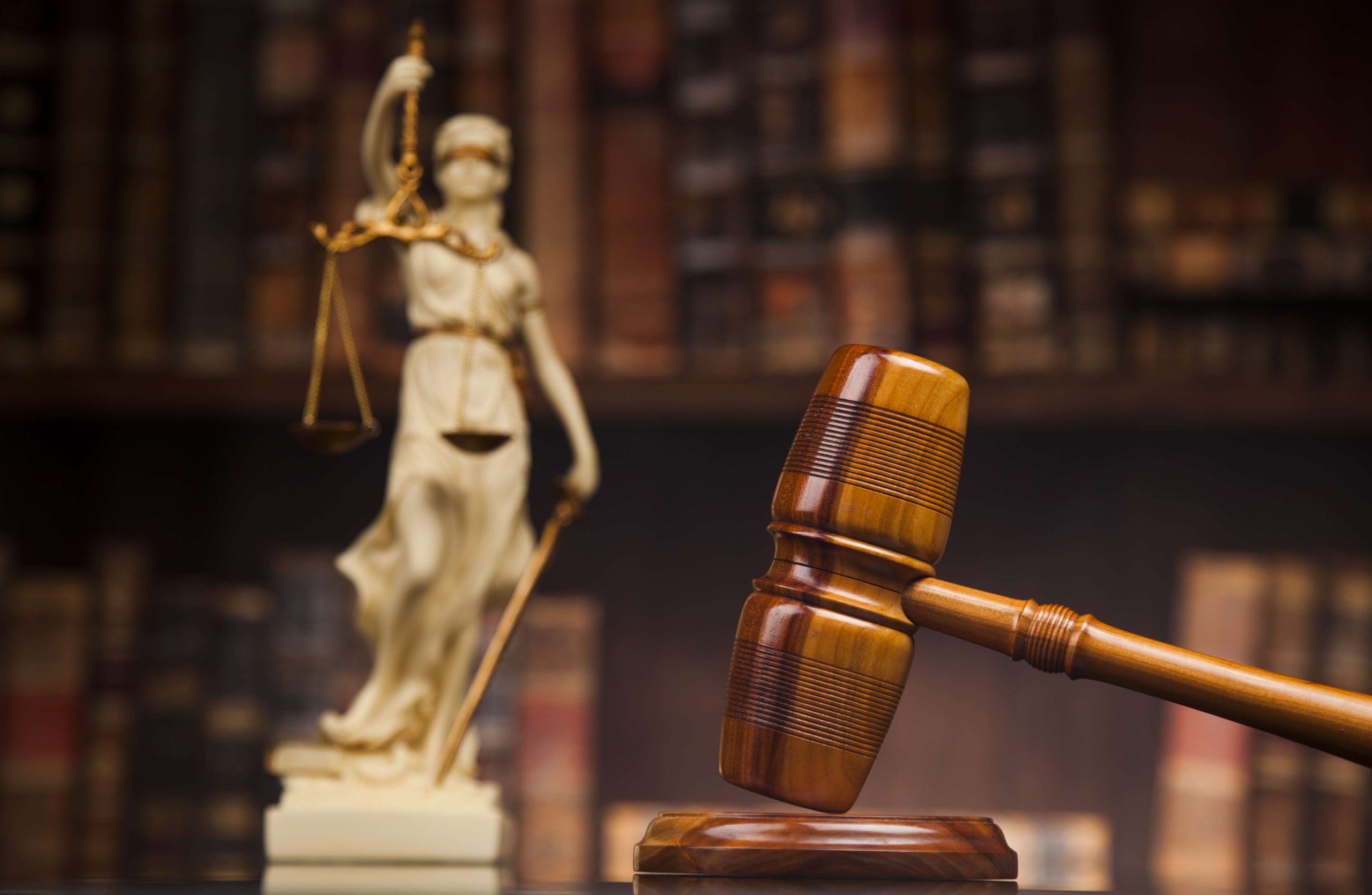 Antique statue of justice, law, books background