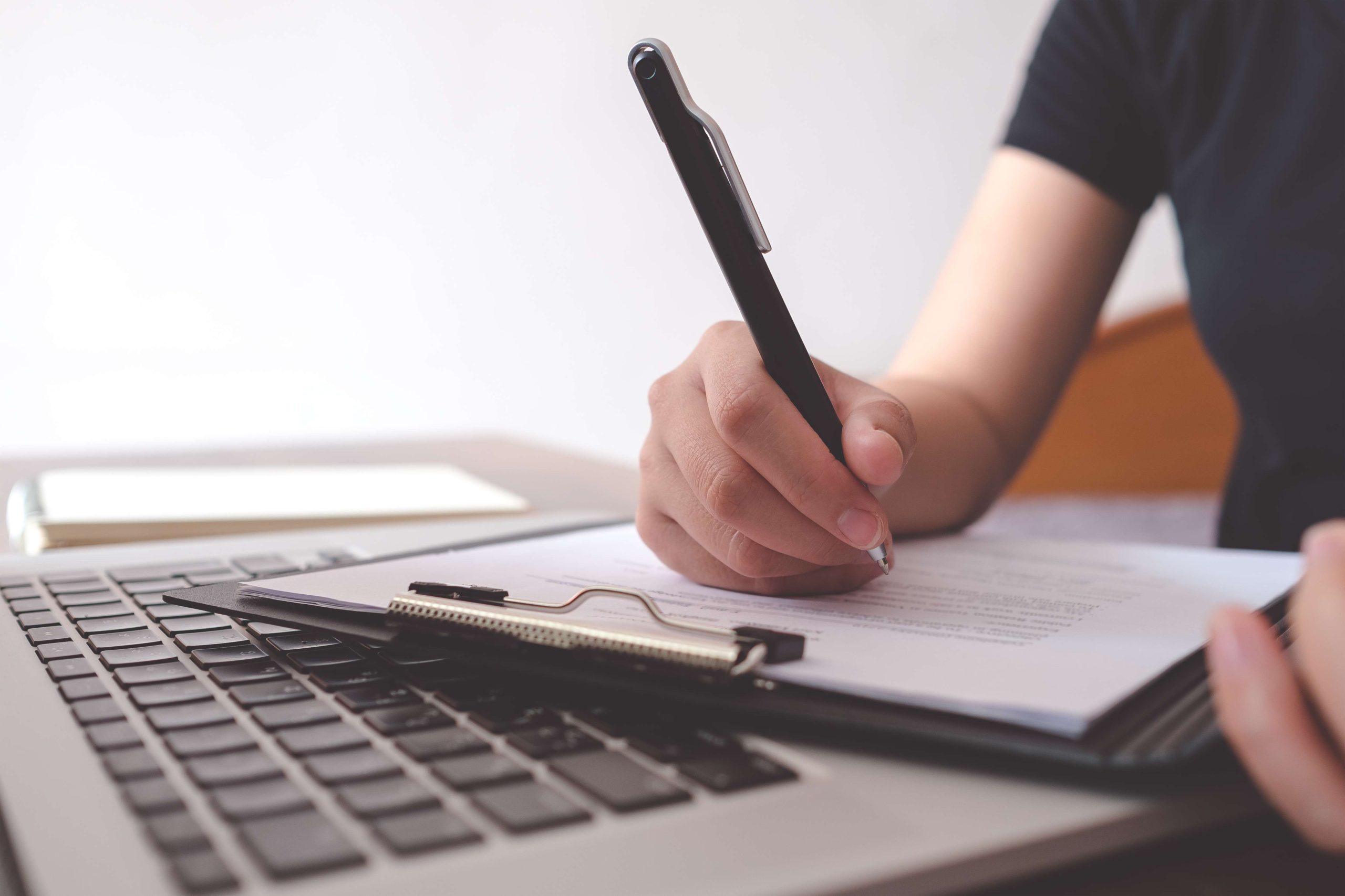 Female writing resume to get new job