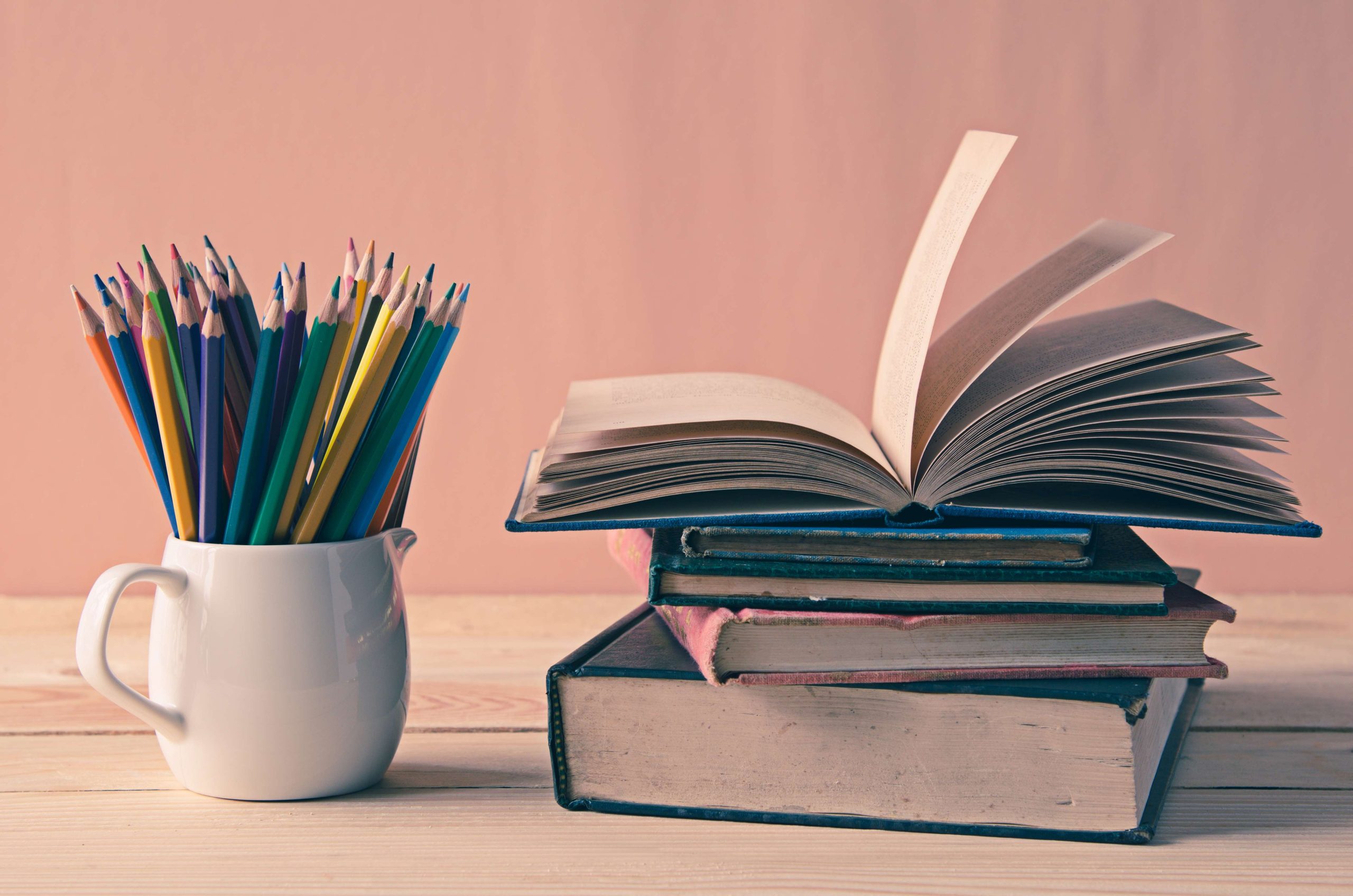 A pile of books on wooden table